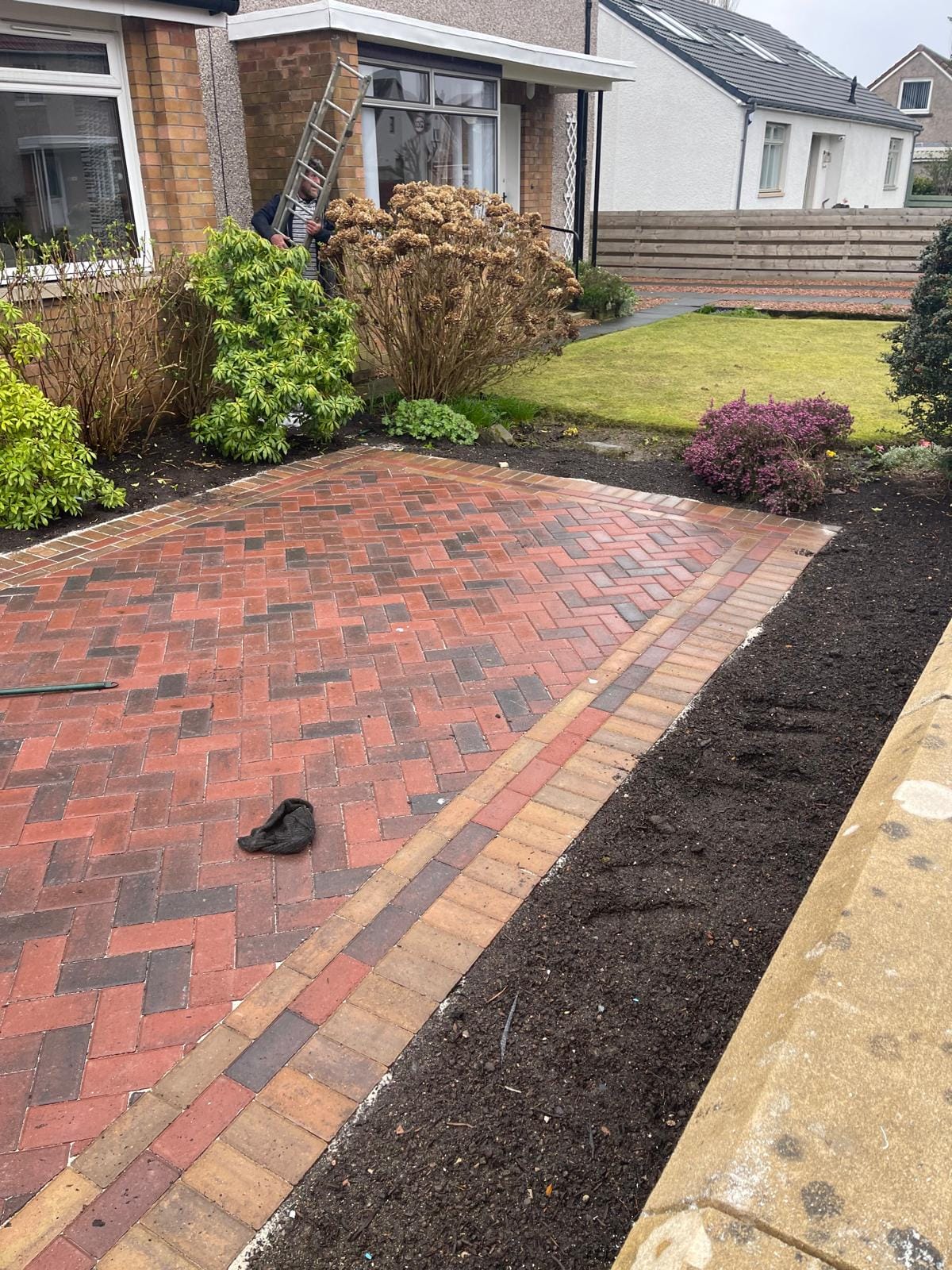Red herringbone block paving driveway with decorative border