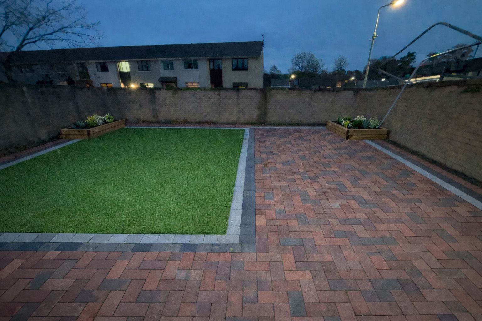 Block paving with artificial grass and raised planters