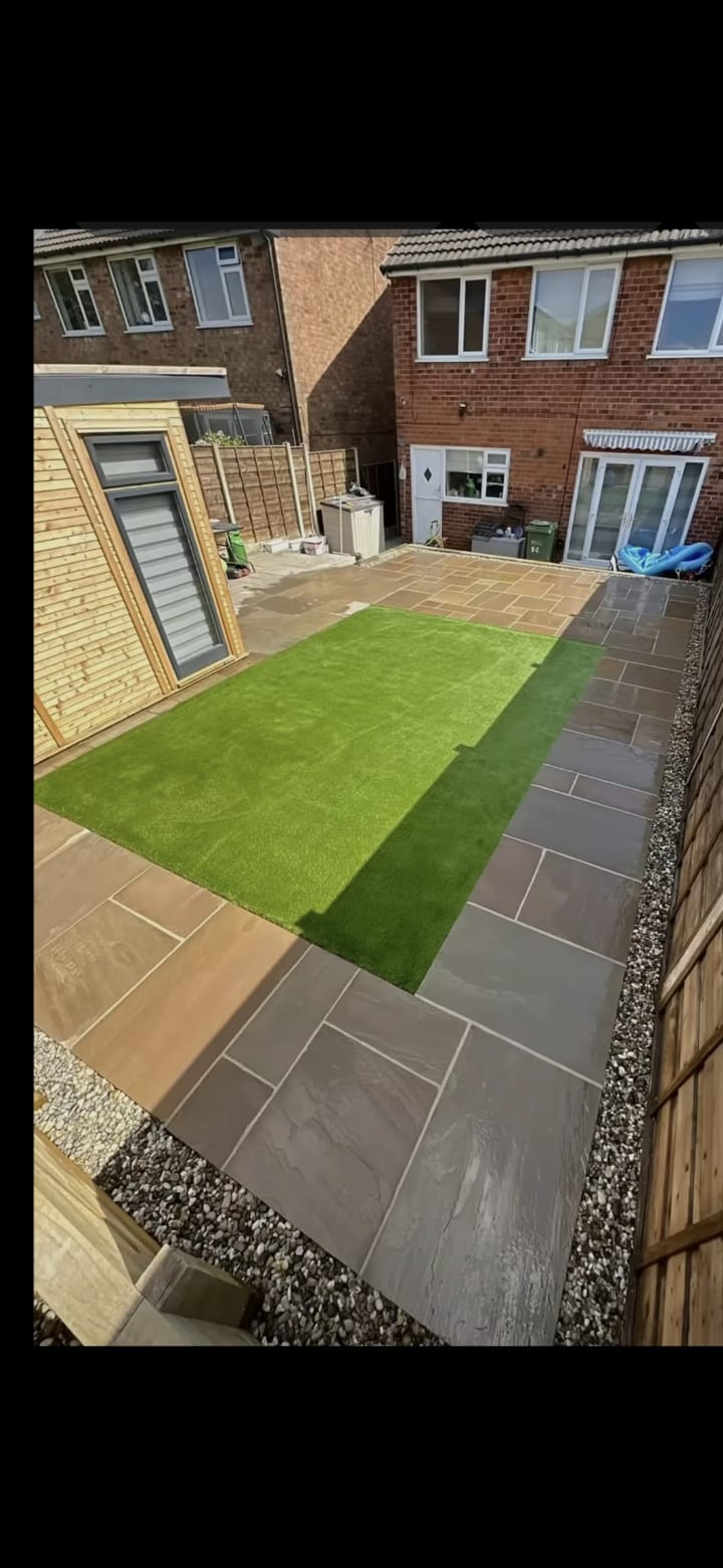 Natural stone patio with artificial grass and gravel edging